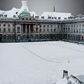 Classical Building Courtyard With Snow Covered Ground Green Dome Arched Windows Columns And Surrounding Railings