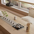 Minimalist Tea Set Arrangement On Wooden Table With Natural Mat And Window View