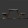 Weathered Wooden Picnic Table With Benches On Outdoor Dirt And Gravel Ground