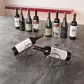 Elegant Assorted Wine Bottles And Glasses Display With Metal Wine Rack On Gray Countertop
