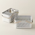 Two White Storage Baskets With Beige Handles And Hollowed Out Design