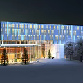 Modern Office Building With Glass Curtain Wall Night Lighting And Trees On Snowy Ground