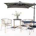 Outdoor Metal Frame Woven Chairs With Small Round Table Striped Umbrella And Green Plant