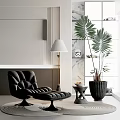 Black Modern Leisure Chair With Ottoman Floor Lamp And Palm Plant On Round Rug