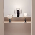 Modern Table Lamps on Light Colored Shelf with Transparent and Curved Shades