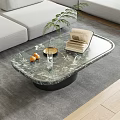 Oval Marble Top Coffee Table With Green Plant Gold Tray Oranges And Books On Rug