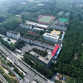 School Building With White Red Brick Walls Multiple Windows Front Square People And Cloudy Sky