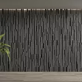 Black Textured Background Wall with Vertical Stripes and Green Potted Plant on Light Wood Floor