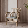 Wicker Leisure Chair with Armrests Soft Cushions Wooden Wall and Floor Green Plant
