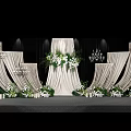 Modern Wedding Banquet Hall With White Curtains Floral Arrangements And Chandeliers On Stage