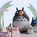 Landscape Sculpture Featuring Cartoon Style Totoro Shaped Figures Various Sizes Pink Steps And Human Figure