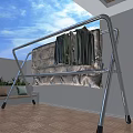 Metal Clothes Drying Rack With Hanging Shirts Jeans And Floral Blanket On Balcony