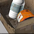 Household Items In Open Cardboard Box With White Bottle Blue Cap And Orange Can