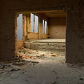 Dilapidated Abandoned Building Interior With Broken Bricks Windows And Concrete Structures