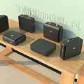 3D Models of Multiple Black Leather Cases on Wooden Table