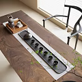 Elegant Tea Set Arranged On Wooden Table With Tray Cups And Green Plants Near Chair