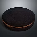 Thick Round Dark Chocolate Cookie with Cream Filling on Gray Surface