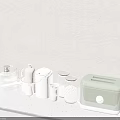Modern Kitchenware on Gray Countertop with Silver Pot White Jars Pink Cups and Green Toaster