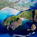 Scenic Garden Landscape With Lush Vegetation Rocky Outcrops Clear Blue Water And Sandy Beach