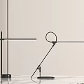 Modern Black Metal Table Lamps Featuring Cross Base And Circular Design On Marble Tabletop