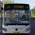 White Modern City Bus With Open Doors And Green Tree Surroundings
