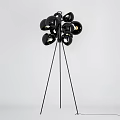 Modern Multi Head Floor Lamp With Black Metallic Shades And Lit Bulbs