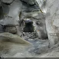 Natural Cave Interior Featuring Rock Formations And Central Stone Opening With Textured Walls