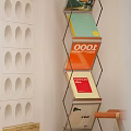 Modern Metal Frame Bookcase with Colorful Books and Circular Cutouts Wall