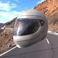 Gray Helmet on Mountain Road with Blue Sky and Reddish Brown Mountains