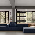 Modern Living Room Interior Design With Blue Sofa Ottoman Small Round Table And Bookshelves
