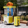 Sweet Heart Souffle Mobile Street Food Cart With Bicycle And Pedestrians Near Modern Building