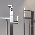 Sleek Silver Faucets With Long Metal Pipes In Arched Niche On Light Gray Wall