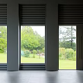 Modern Floor To Ceiling Windows With Dark Frames And Lush Green Garden View