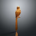 Golden Parrot Sculpture Standing on Branch with Gray Background and Reflection