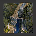 Historic Stone Arch Bridge Spanning River Amidst Green Trees And Natural Landscape