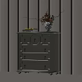 Stylish Light Gray Chest of Drawers With Decorative Panels Vase and Books in Sunlight