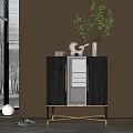 Black Entryway Side Cabinet With Glass Doors Gold Accents And Decorative Items On Wooden Wall