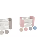 Modern Baby Crib With Pink Padded Sides White Railings And Wooden Legs