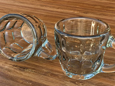 Two Transparent Glass Mugs With Raised Textures Upside Down And Upright On Wooden Tabletop 3d model