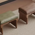 Two Green and Brown Leather Cushioned Stools with Wooden Legs on Carpet