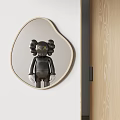 Heart Shaped Mirror Reflecting Black Doll With XX Eyes Against White Wall And Wooden Door