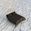 Ornate Golden Double Bed With Black Sheets And Pillows On Green Grass