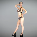 Woman in Black Lace Bikini Posing with High Heels on Gray Background