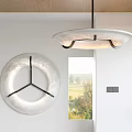 Modern Circular Pendant Light With Sleek Design Above Window And Wall Decor