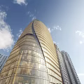 Tall Modern Office Building With Curved Glass Facade And Blue Sky Surroundings