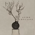 Black Ceramic Vase with Dried Branches on White Pedestal Against Neutral Wall AUDO CONCEPT Decor