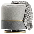 Modern Round Gray Upholstered Ottoman With Houndstooth Blanket And Gold Trim