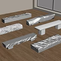 Different Textured Stone Benches Arranged On Wooden Floor With Natural Light