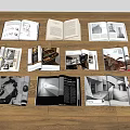 Open Books Featuring Black And White Photos Text And Architectural Images On Wooden Floor