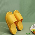 FUSHIA Yellow Slippers Comfortable Slip On Design Soft Rubber Material Against Green Wall And Table
